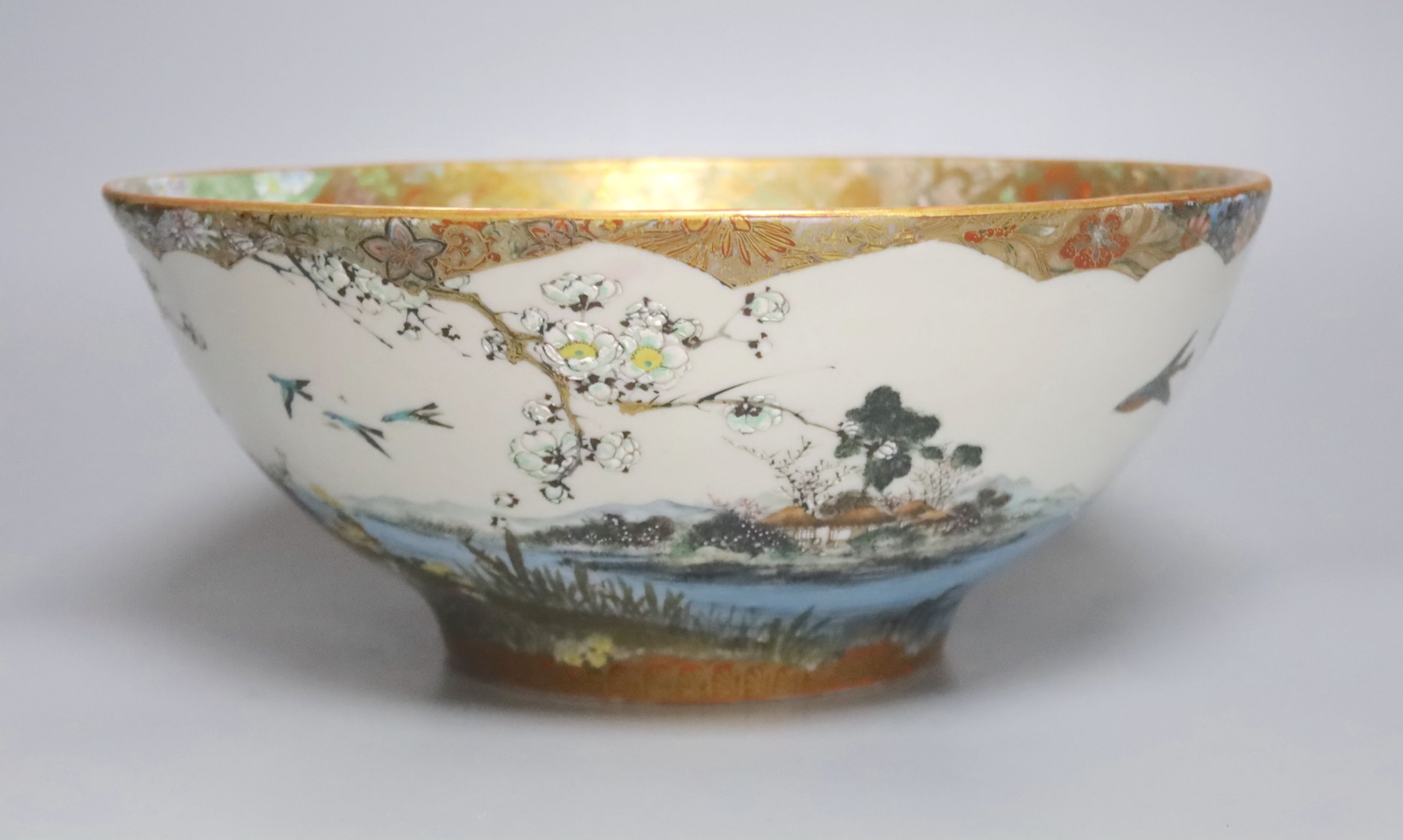 A large early 20th century Japanese Kutani bowl, painted with peacocks and flowers, 13cm high, 31cm diam